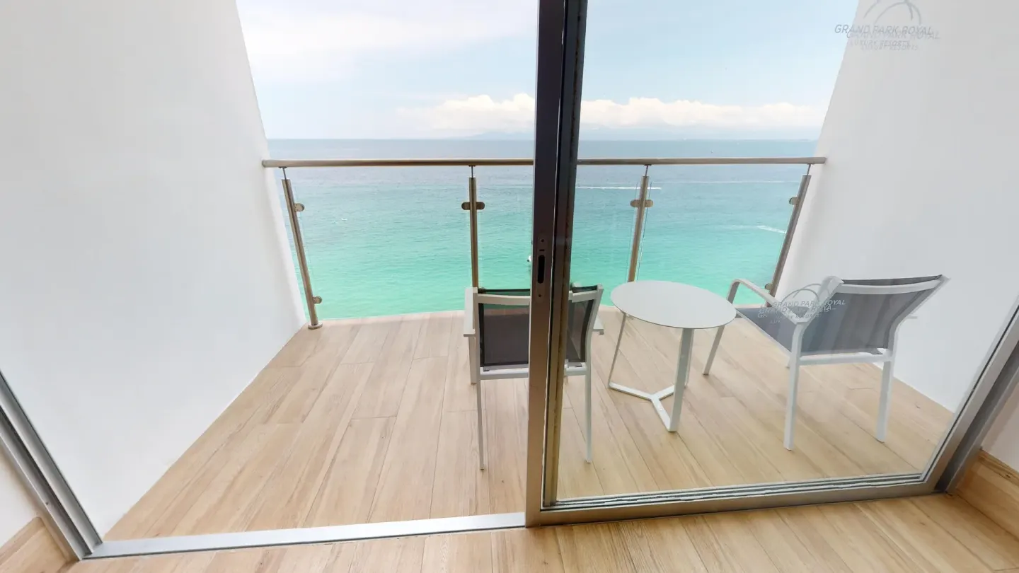 Premier Ocean Front balcony with chairs and ocean view at Grand Park Royal Puerto Vallarta.