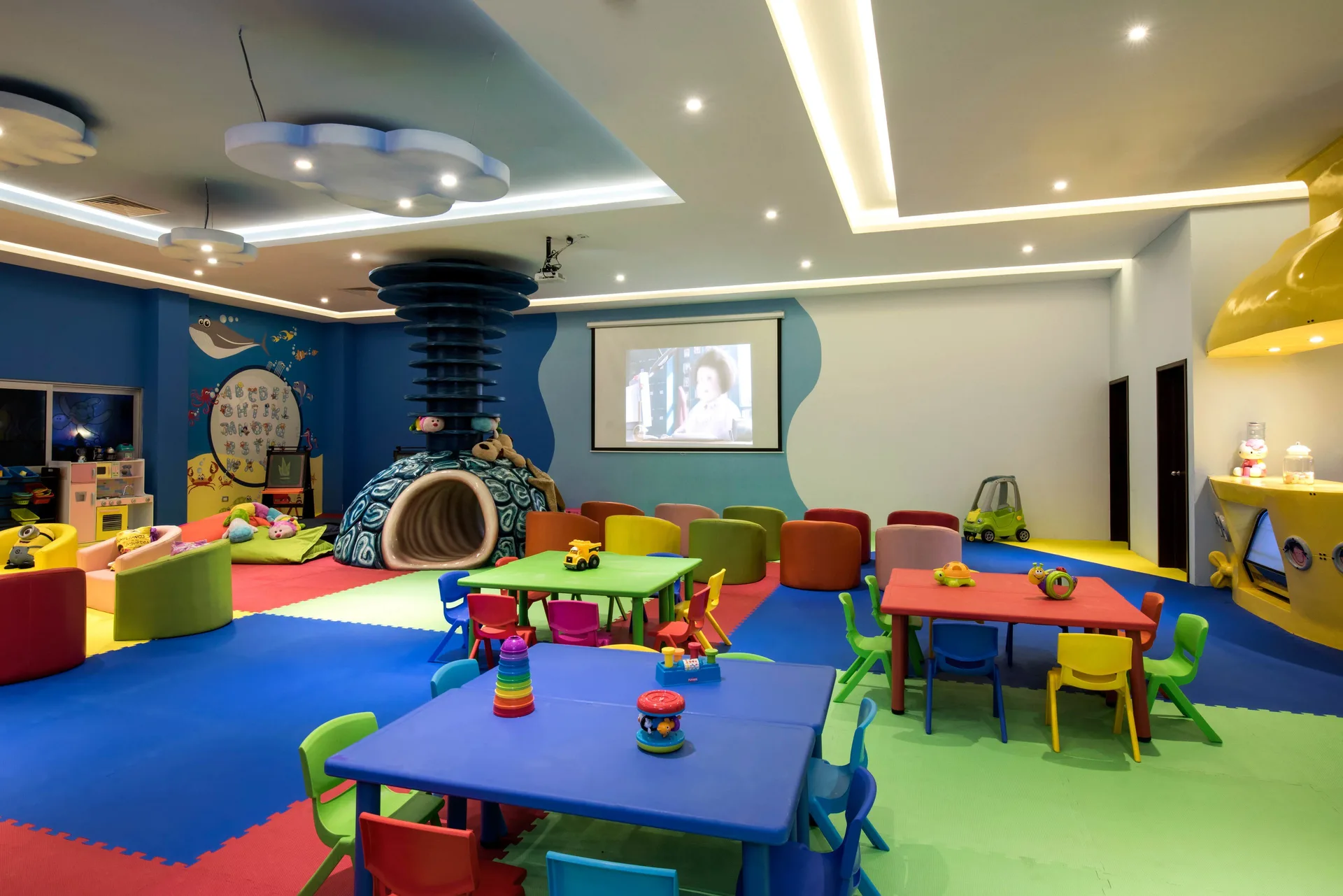 Colorful children's playroom with tables and toys at Grand Riviera Princess.