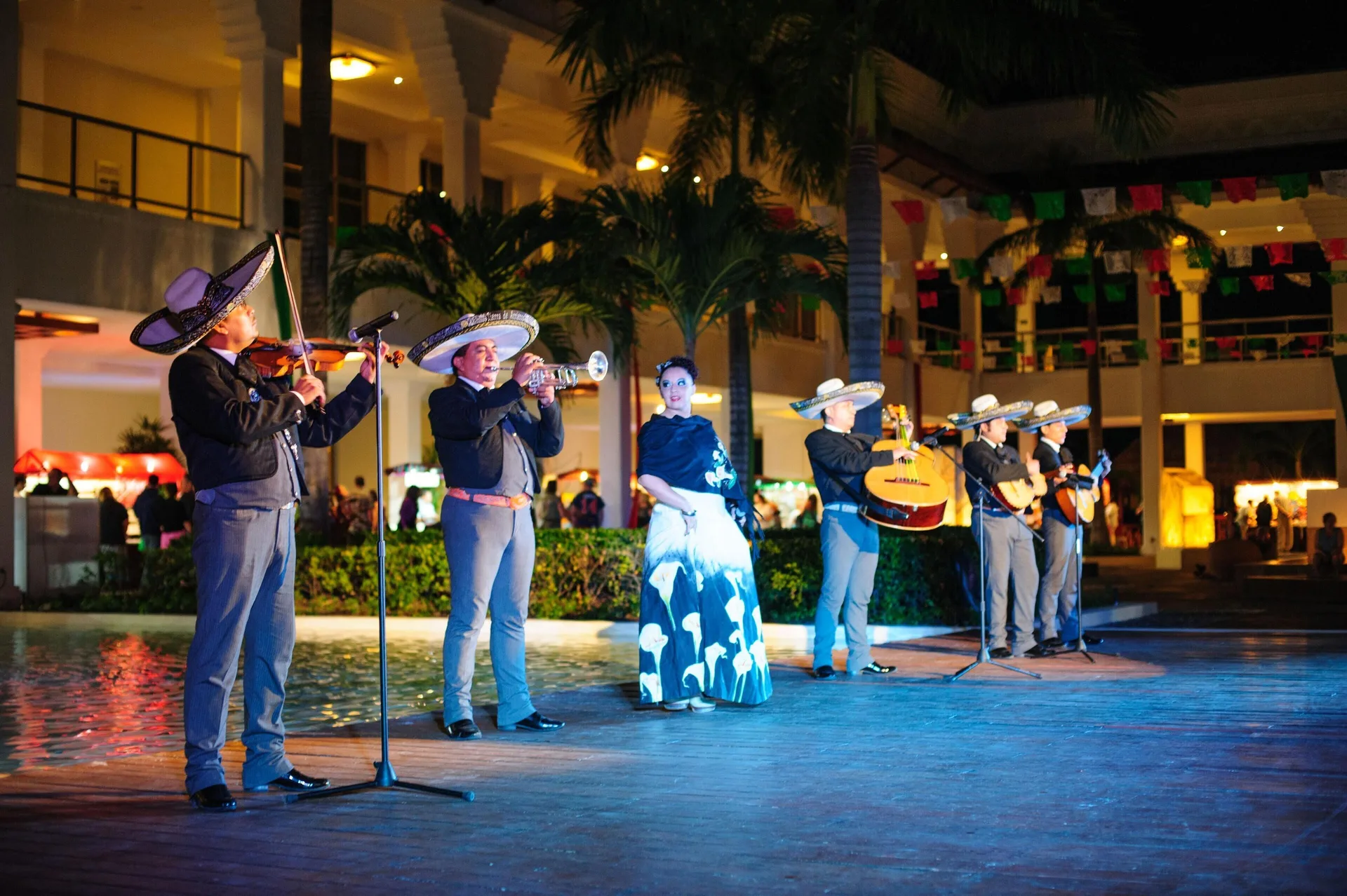 Mariachi musicians perform outdoors at night at Grand Riviera Princess.