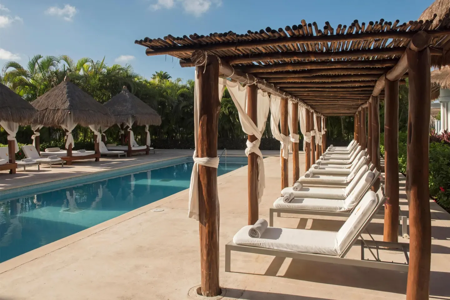 Shaded cabana loungers line a quiet pool at Grand Riviera Princess.