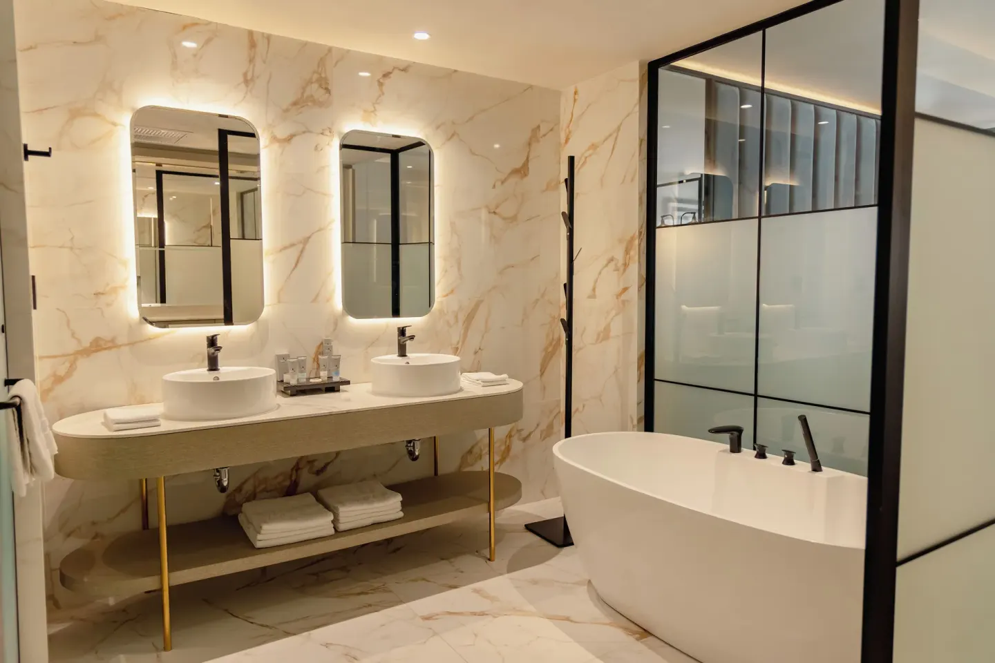Spacious marble bathroom with double sinks and freestanding tub at Grand Riviera Princess.