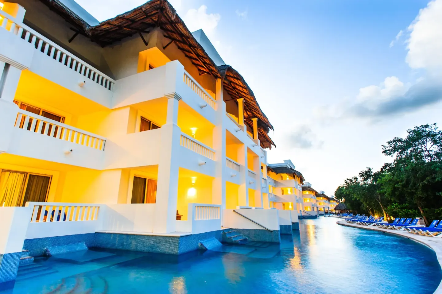 Swim-up room balconies overlook a blue pool channel at Grand Riviera Princess.