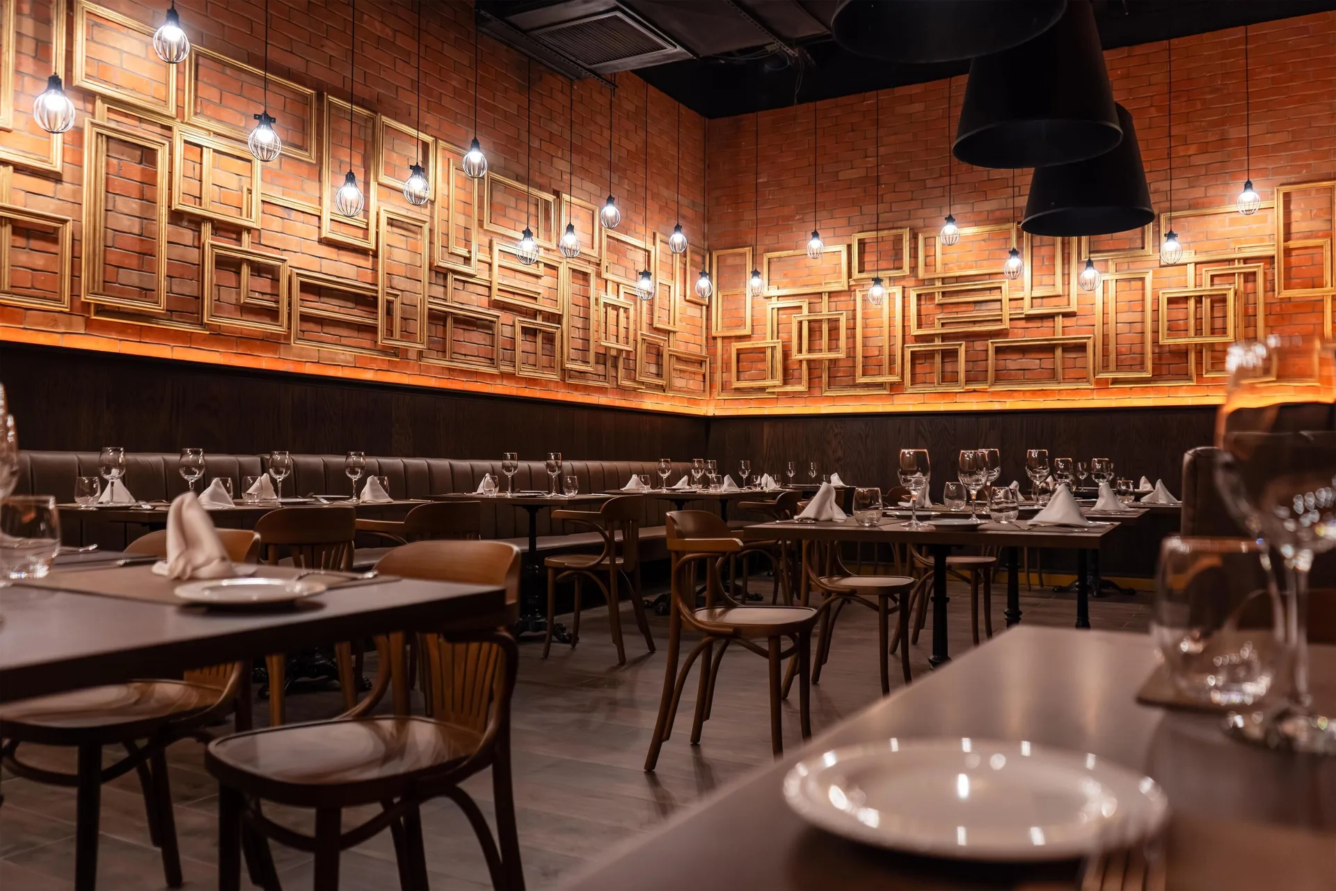 Brick-walled restaurant dining room with set tables at Grand Riviera Princess.