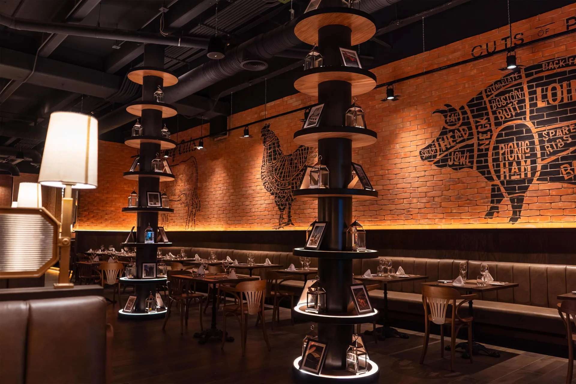 Steakhouse-style dining room with meat-cut wall art at Grand Riviera Princess.