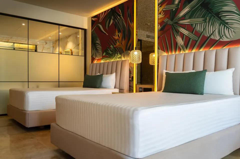 Deluxe Room Garden View with two beds and tropical wall art at Grand Riviera Princess.