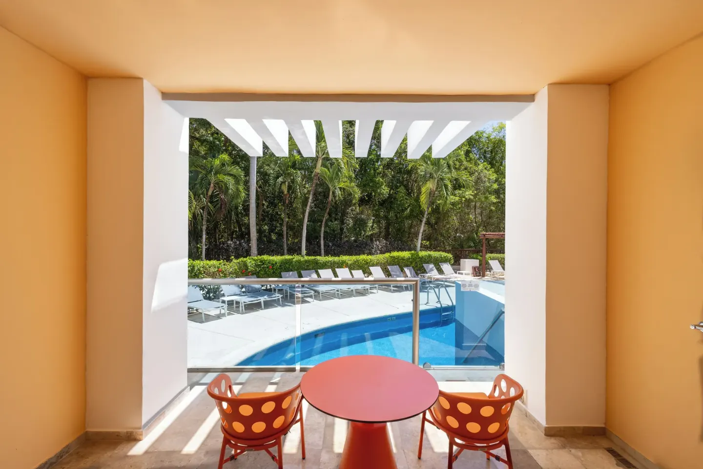 Family Club Pool Access balcony with table and pool view at Grand Riviera Princess.