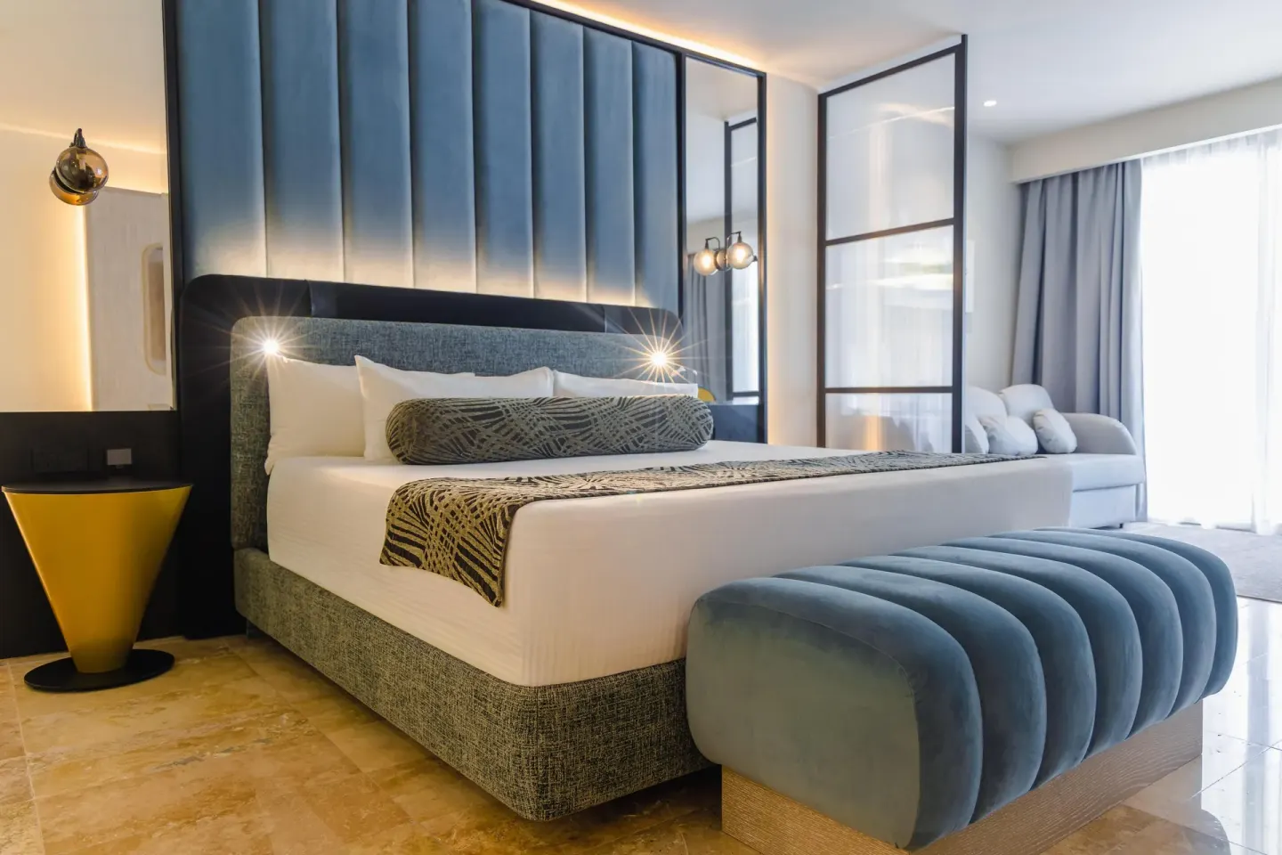 Platinum Suite king bed with blue bench at Grand Riviera Princess.