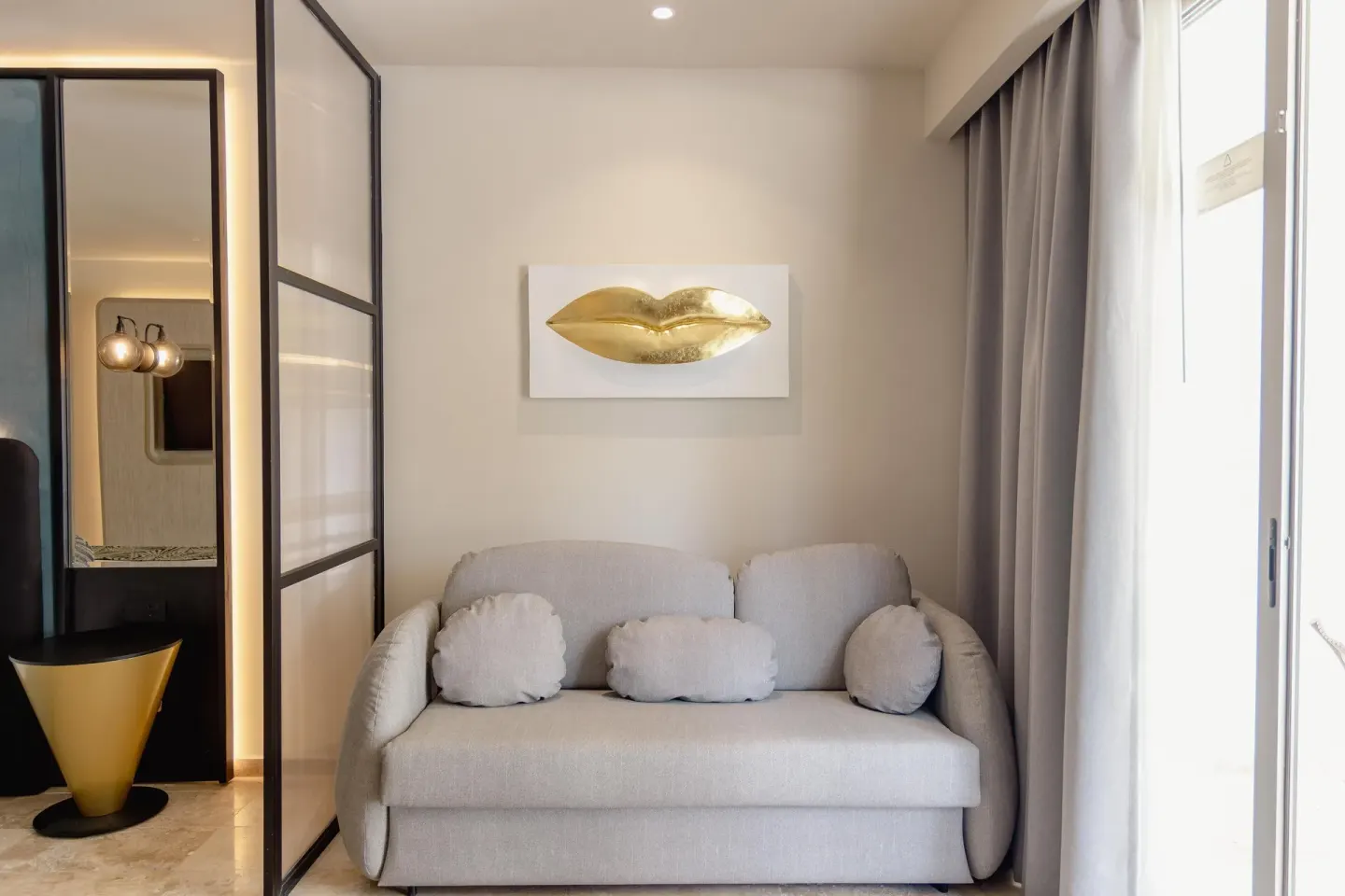 Platinum Suite sofa beside bright window at Grand Riviera Princess.