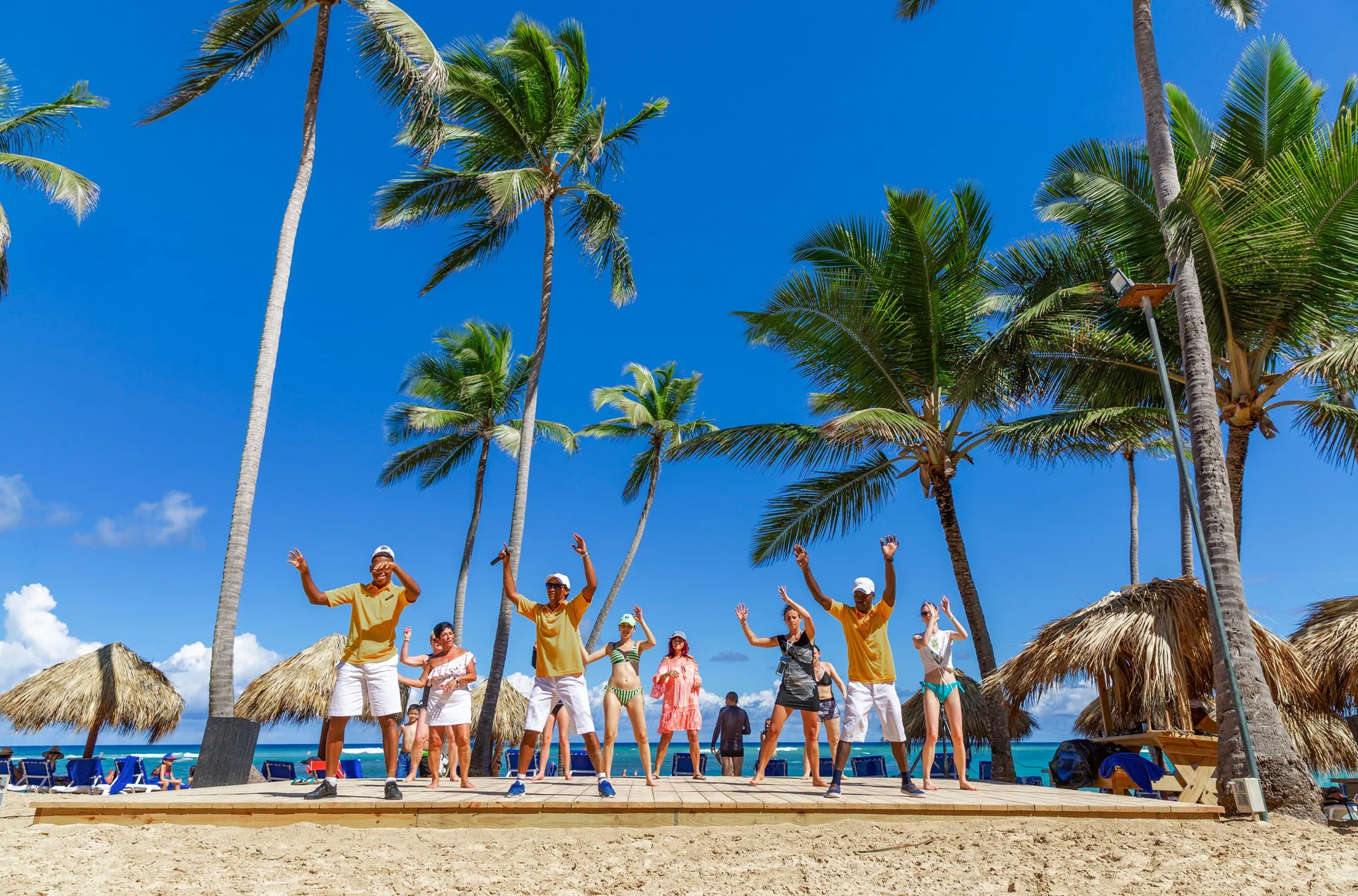 Beach activity leaders dancing with guests at Grand Sirenis Punta Cana Resort & Aquagames.