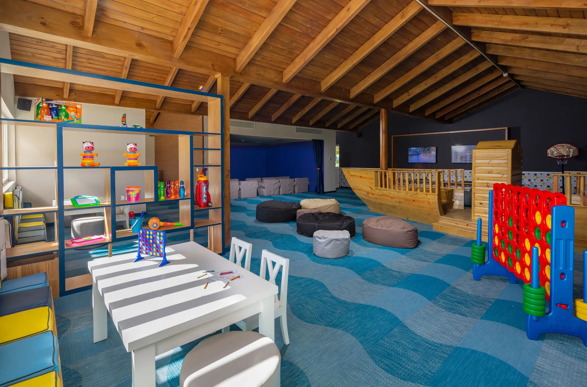 Children’s playroom with games, beanbags, and tables at Grand Sirenis Punta Cana Resort & Aquagames.