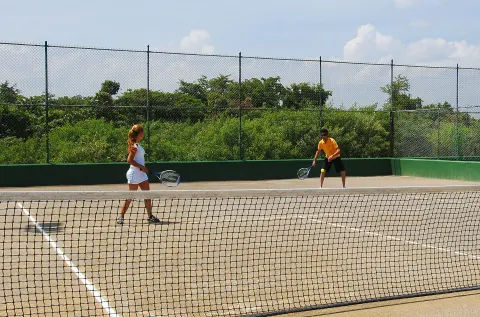 Guests playing tennis on an outdoor court at Grand Sirenis Punta Cana Resort & Aquagames.