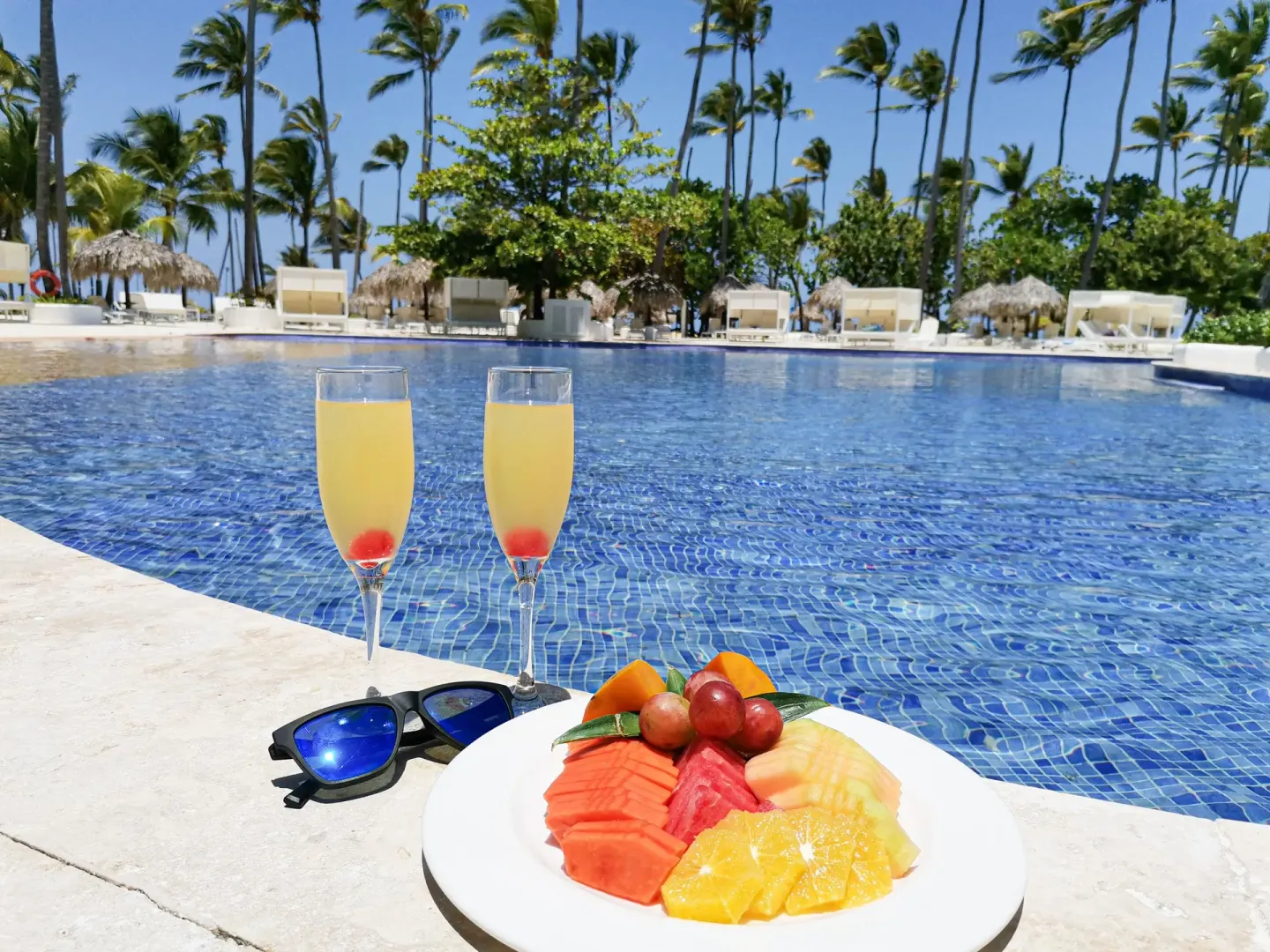 Fruit plate and drinks by the pool at Grand Sirenis Punta Cana Resort & Aquagames.