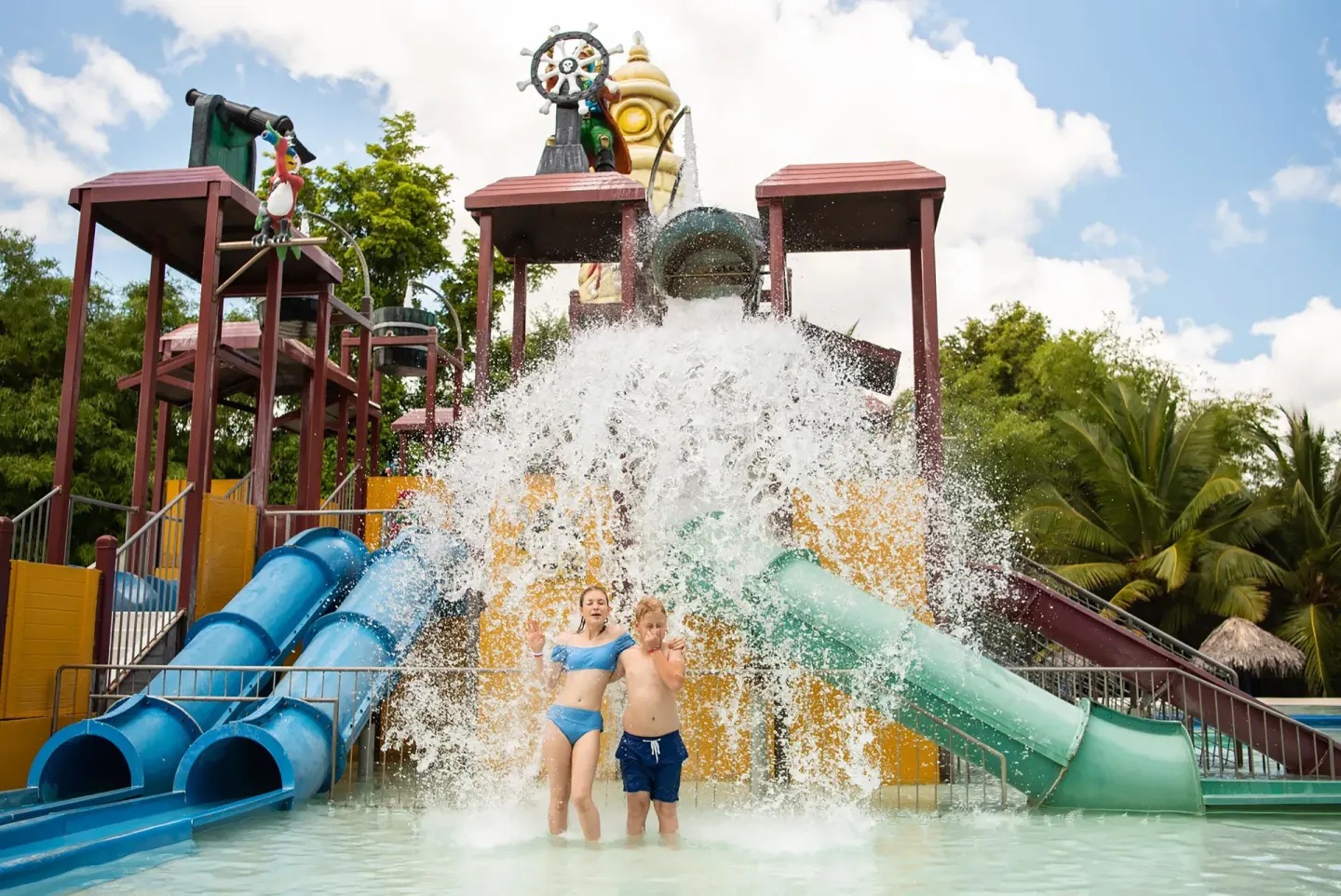Children standing under a splash bucket at Grand Sirenis Punta Cana Resort & Aquagames.