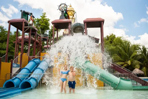 Children standing under a splash bucket at Grand Sirenis Punta Cana Resort & Aquagames.