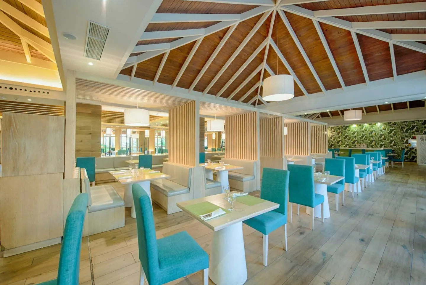 Airy restaurant with turquoise chairs at Grand Sirenis Punta Cana Resort & Aquagames.