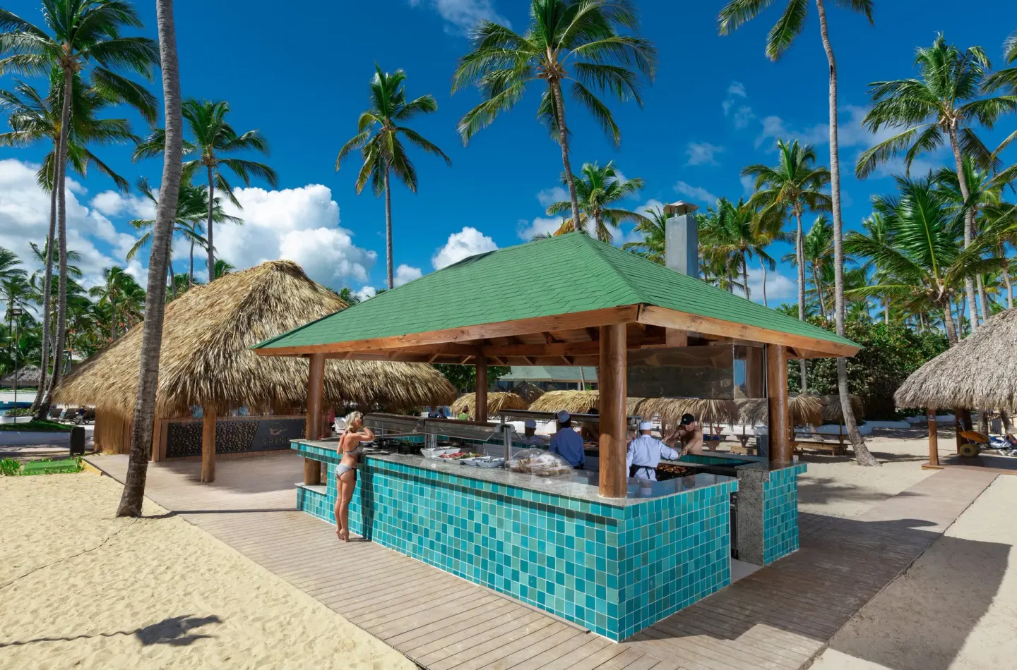 Beachside food bar with turquoise tile and palm trees at Grand Sirenis Punta Cana Resort & Aquagames.