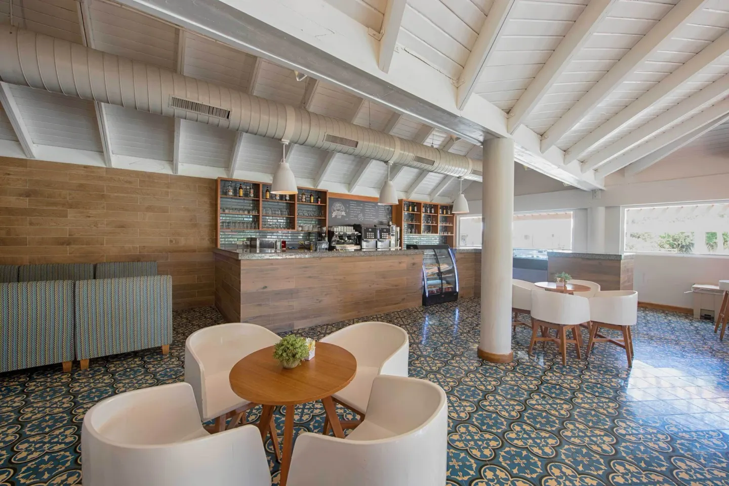 Bright café bar with round tables at Grand Sirenis Punta Cana Resort & Aquagames.