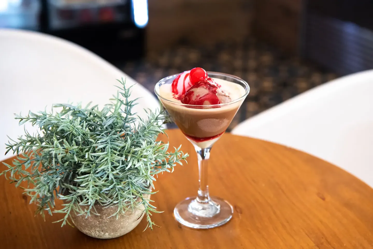 Creamy dessert cocktail with cherry garnish on a table at Grand Sirenis Punta Cana Resort & Aquagames.