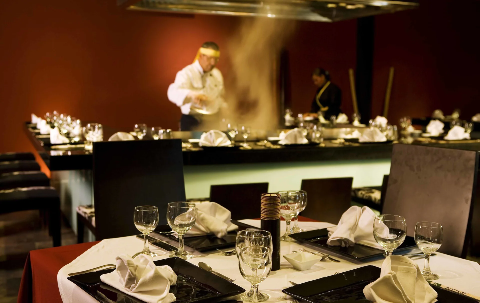Teppanyaki chef cooking in a restaurant at Grand Sirenis Punta Cana Resort & Aquagames.