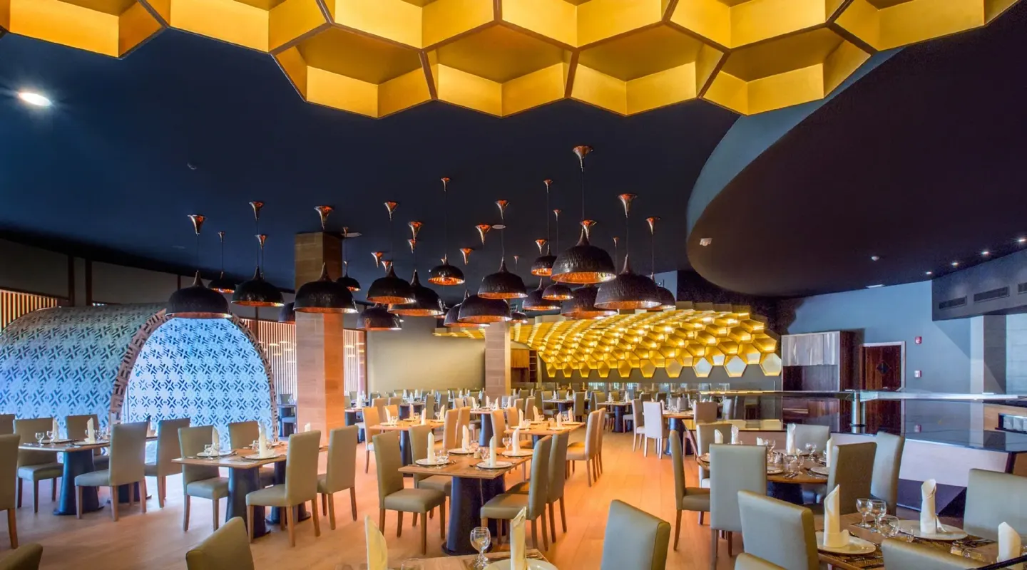 Modern restaurant dining room with honeycomb ceiling at Grand Sirenis Punta Cana Resort & Aquagames.