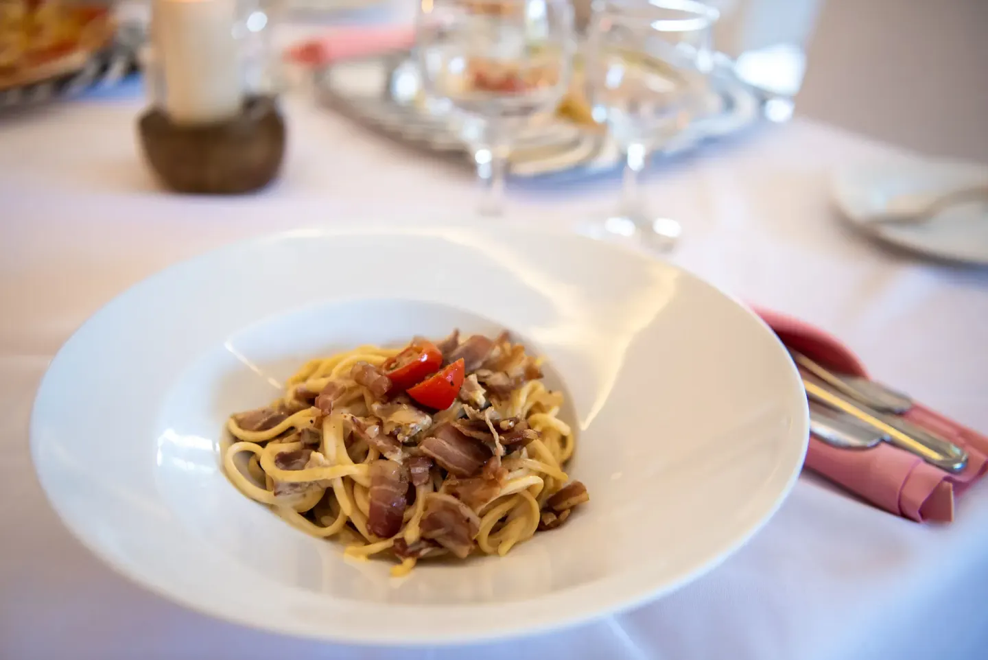 Plated pasta dish on a white table at Grand Sirenis Punta Cana Resort & Aquagames.