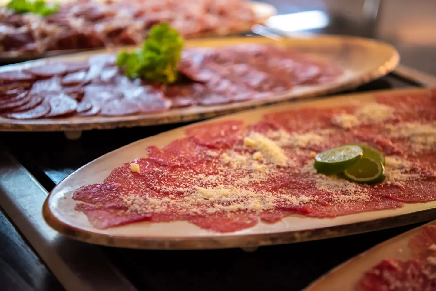 Platters of sliced meats with garnish at Grand Sirenis Punta Cana Resort & Aquagames.