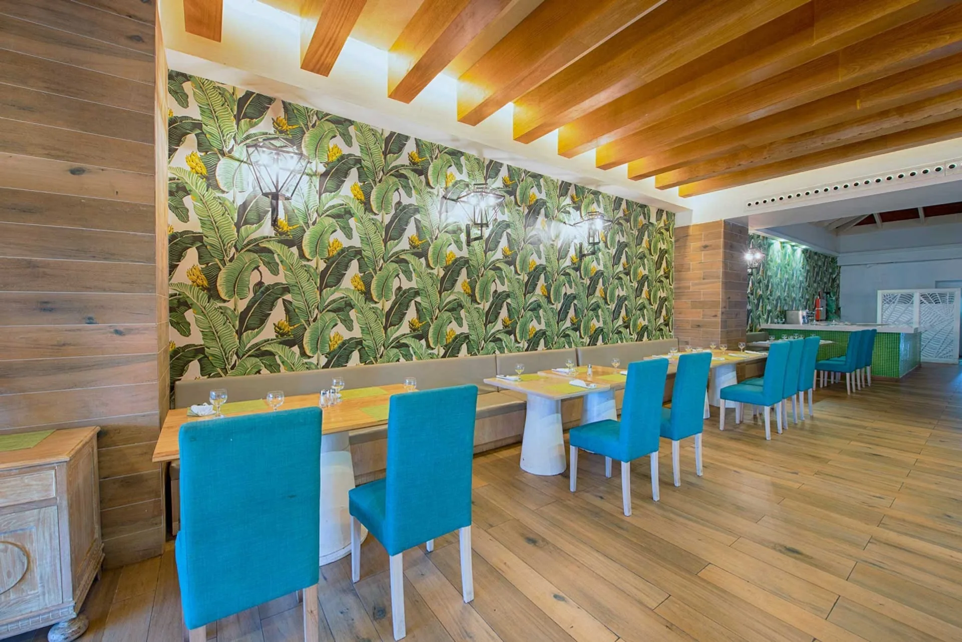 Indoor restaurant seating with teal chairs at Grand Sirenis Punta Cana Resort & Aquagames.
