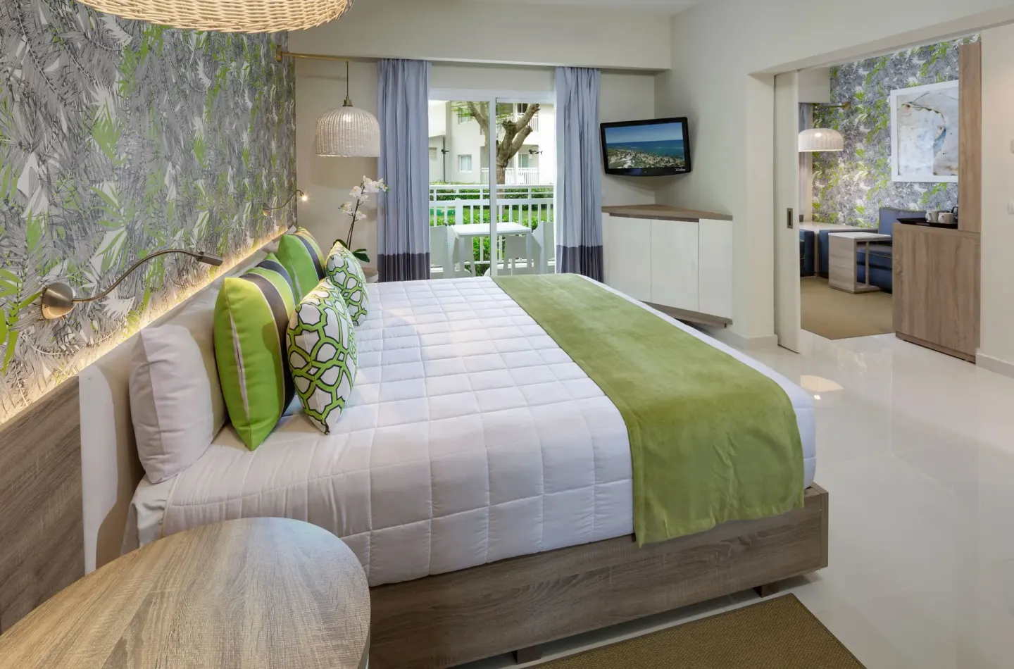 Family Suite bedroom with king bed and balcony at Grand Sirenis Punta Cana Resort & Aquagames.