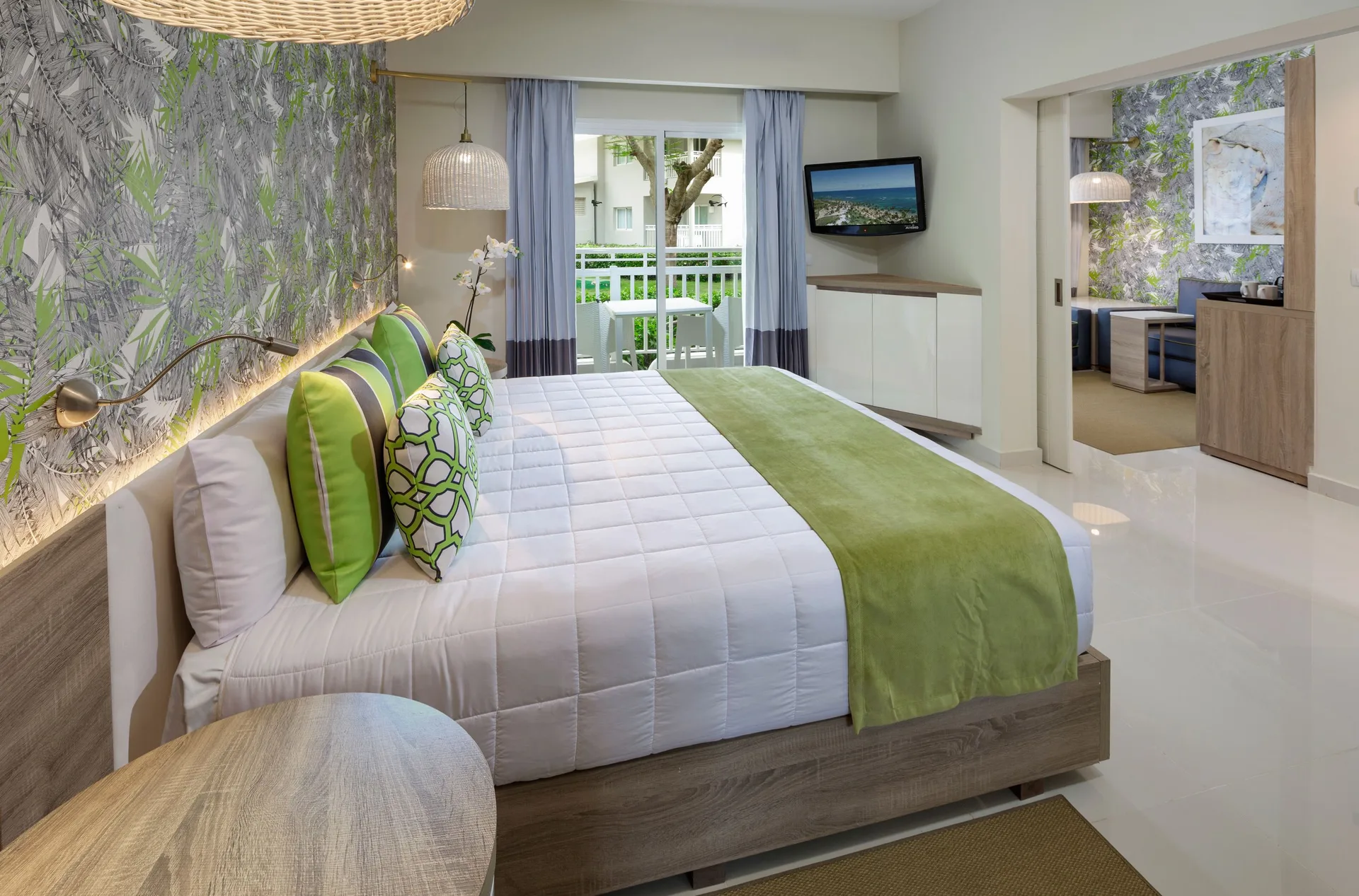 Family Suite bedroom with king bed and balcony at Grand Sirenis Punta Cana Resort & Aquagames.