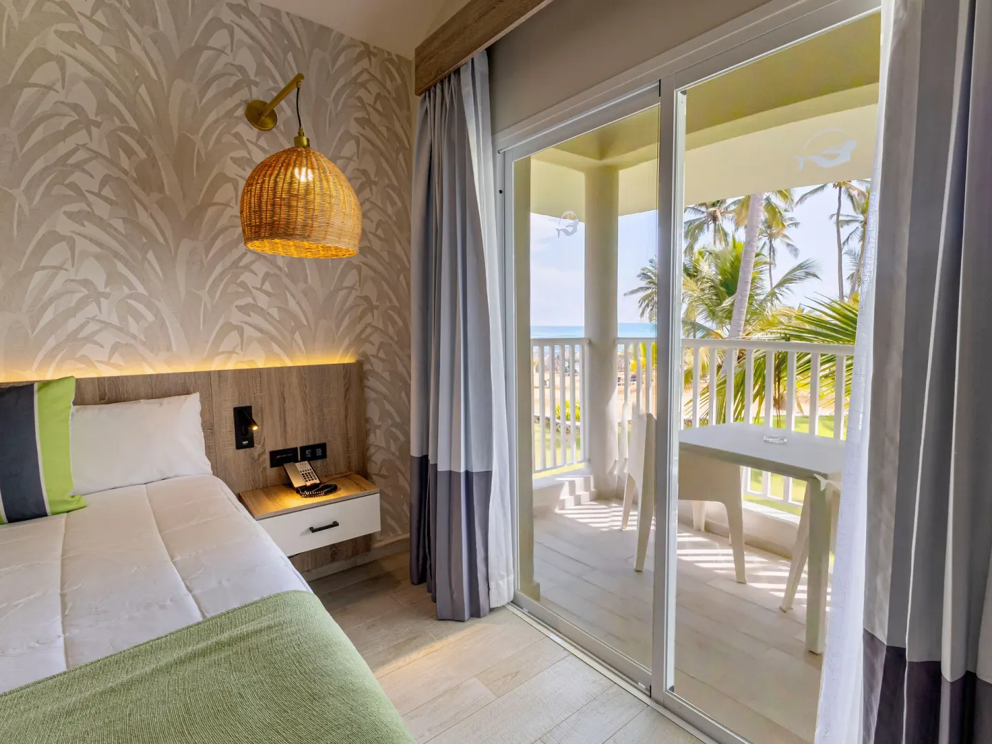 Bedroom balcony with ocean view at Grand Sirenis Punta Cana Resort & Aquagames.