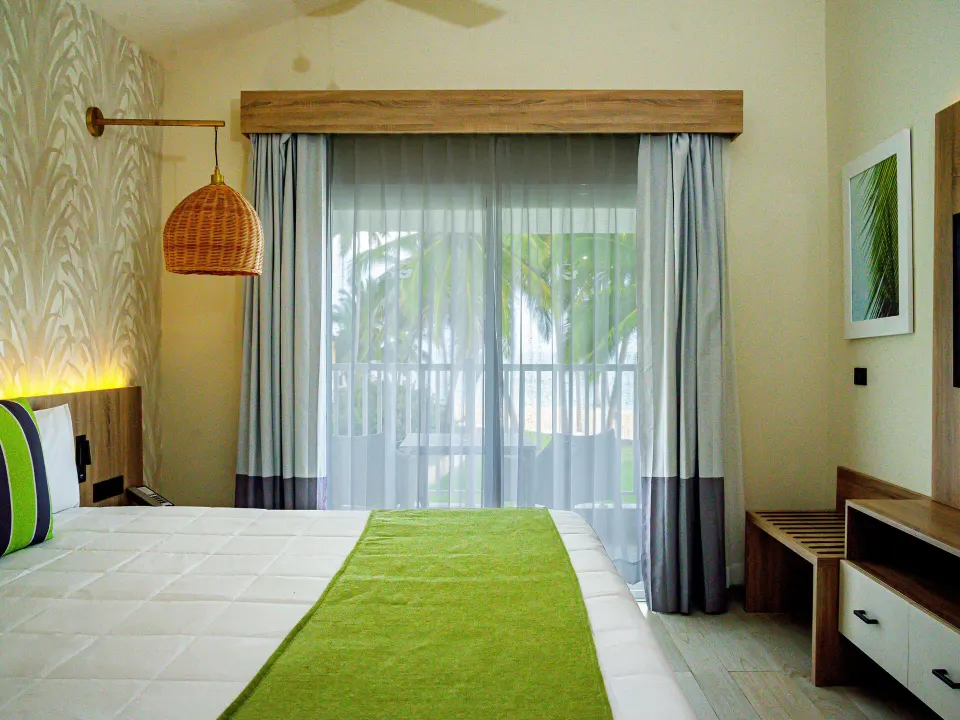 Bedroom with balcony doors in a Family Suite at Grand Sirenis Punta Cana Resort & Aquagames.