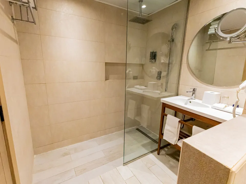 Walk-in shower and vanity in a Family Suite at Grand Sirenis Punta Cana Resort & Aquagames.