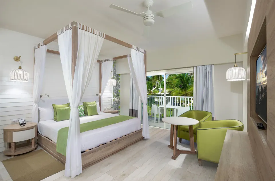 Romantic Room with canopy bed and balcony at Grand Sirenis Punta Cana Resort & Aquagames.