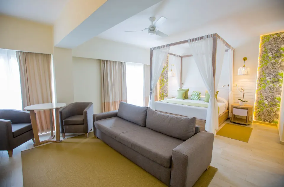 Renovated suite seating area and canopy bed at Grand Sirenis Punta Cana Resort & Aquagames.