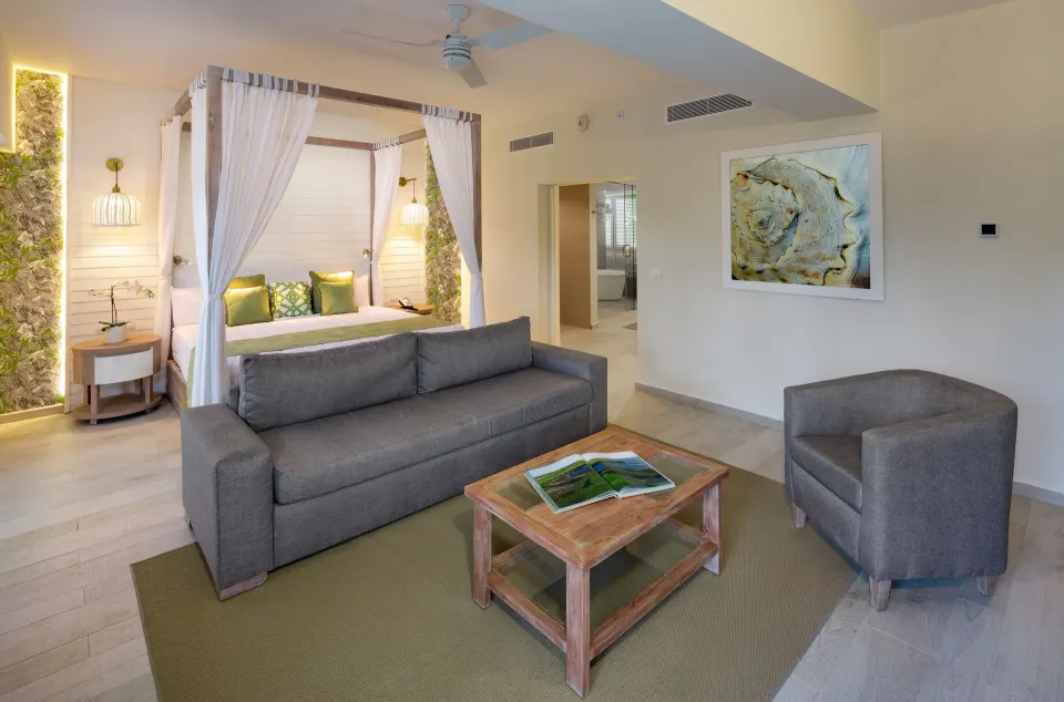 Renovated suite with canopy bed and sofa at Grand Sirenis Punta Cana Resort & Aquagames.