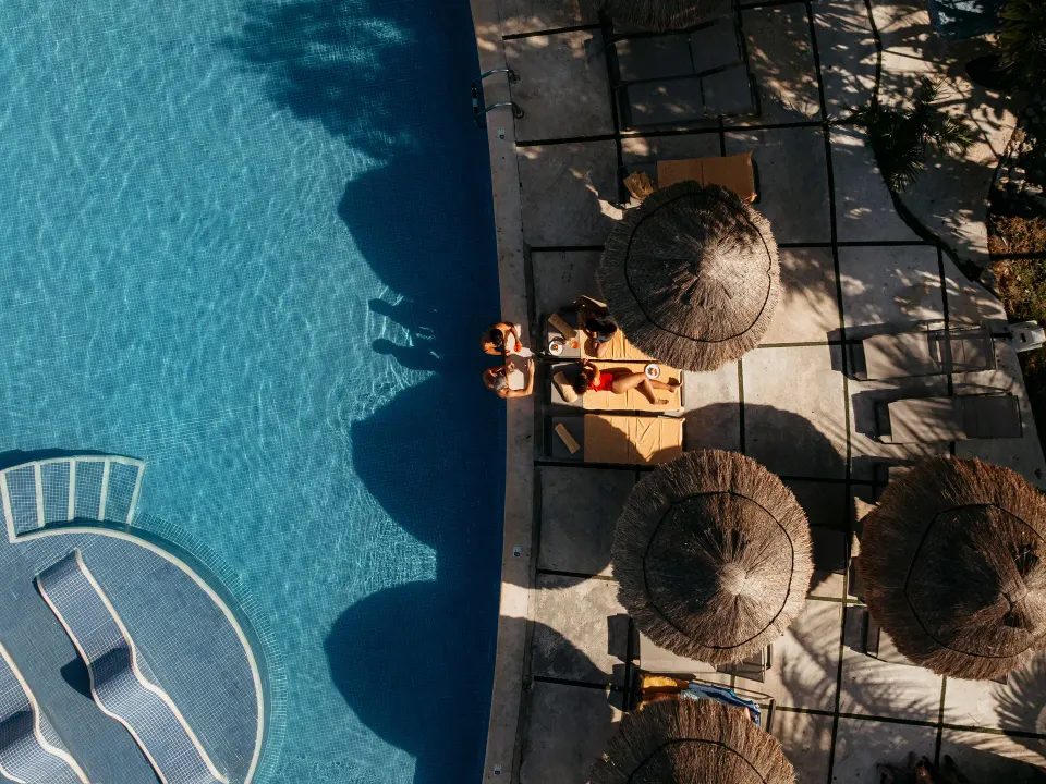 Aerial view of poolside palapas and loungers at Grand Sirenis Riviera Maya Resort & Spa