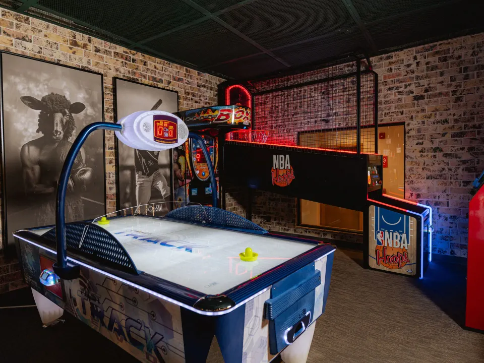 Air hockey and arcade basketball games in a games room at Grand Sirenis Riviera Maya Resort & Spa