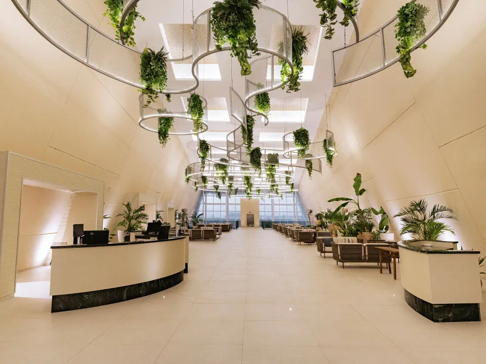 Long central lobby corridor with hanging plant installations at Grand Sirenis Riviera Maya Resort & Spa