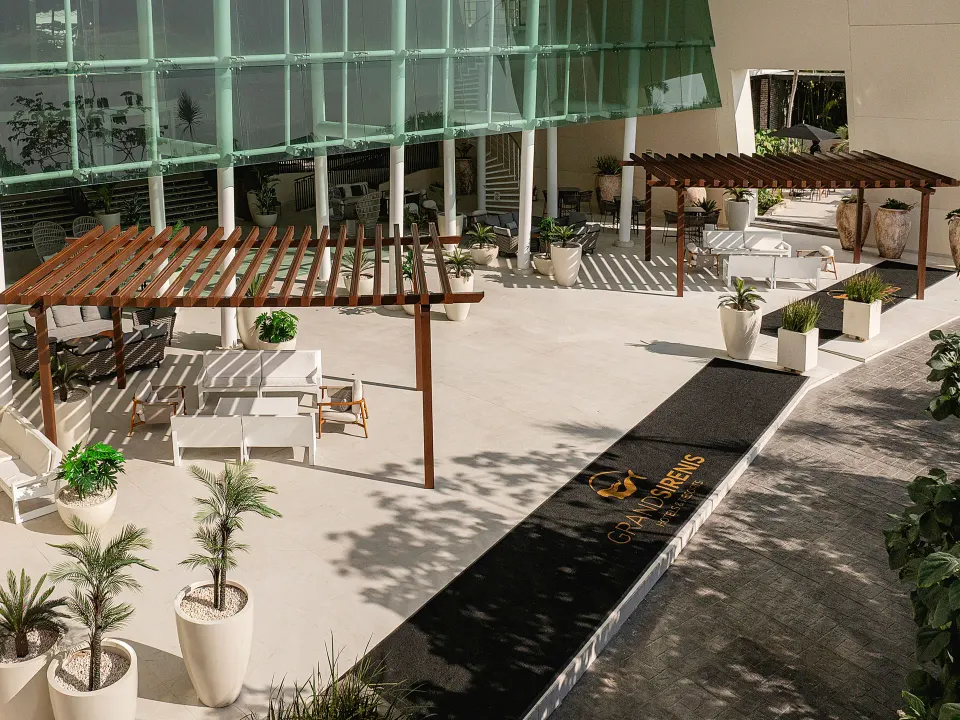 Hotel entrance terrace with pergolas and seating at Grand Sirenis Riviera Maya Resort & Spa