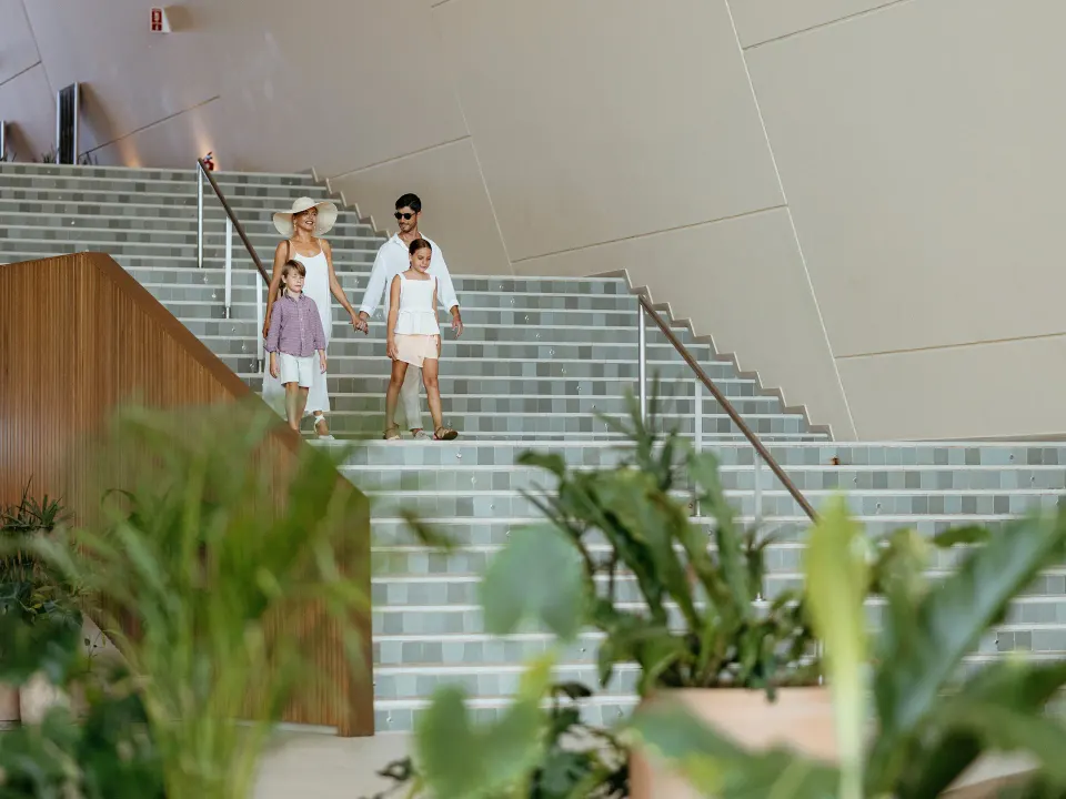 Family descending wide tiled stairs inside the lobby at Grand Sirenis Riviera Maya Resort & Spa
