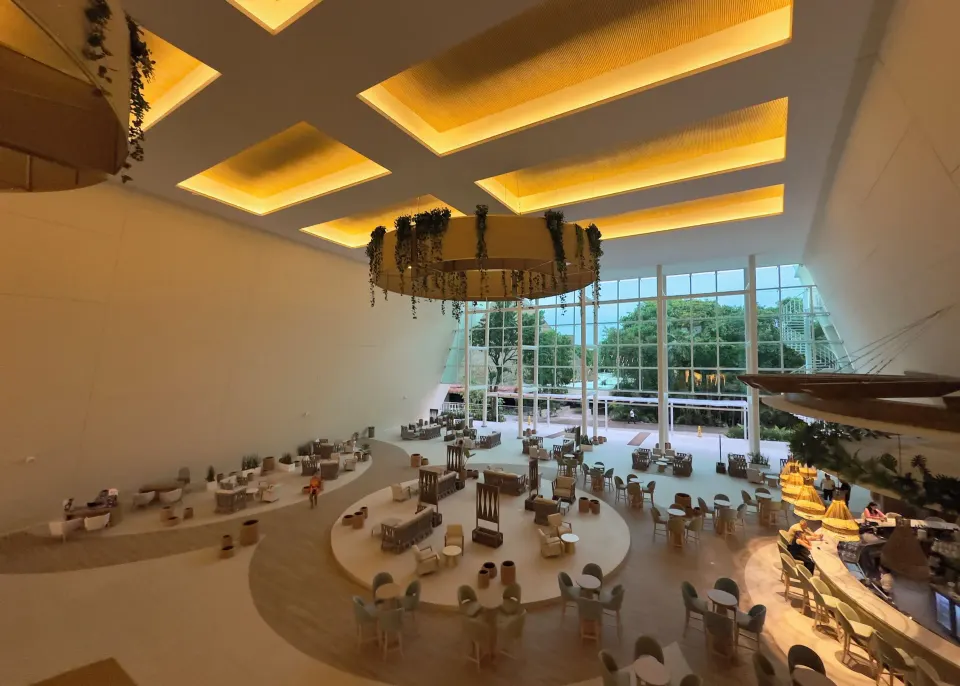 Wide view of the resort lobby seating and floor-to-ceiling windows at Grand Sirenis Riviera Maya Resort & Spa
