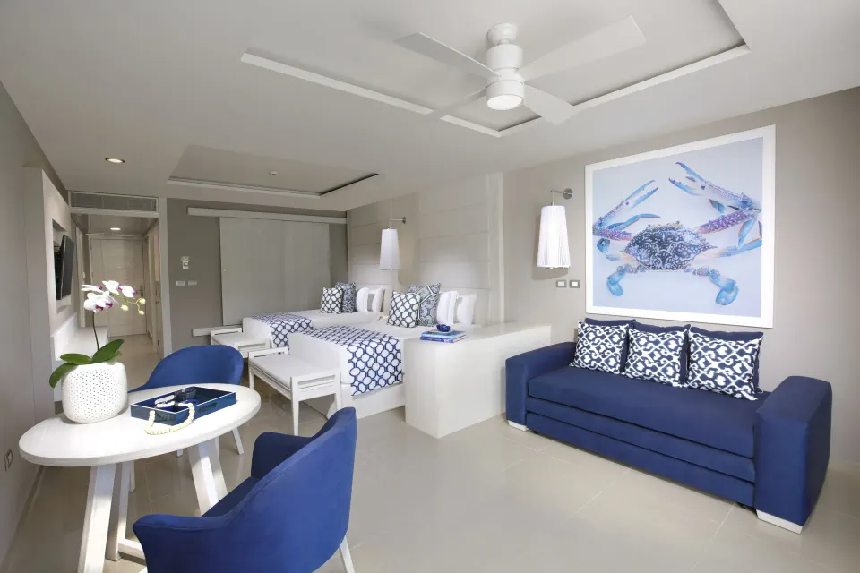 Contemporary junior suite with king bed and seating area at Grand Sirenis Riviera Maya Resort & Spa
