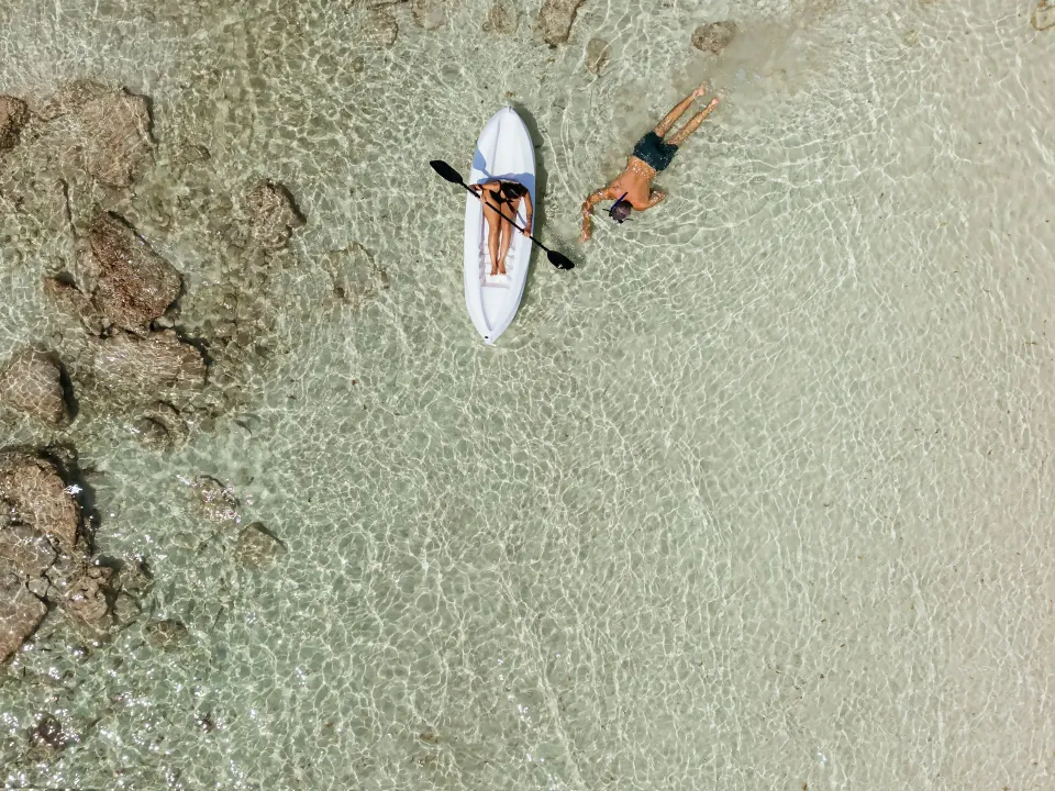 Aerial view of a kayak and a swimmer in shallow water at Grand Sirenis Riviera Maya Resort & Spa