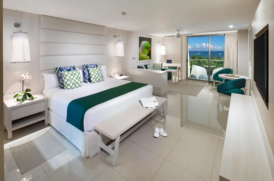 Spacious ocean-view suite with king bed and balcony at Grand Sirenis Riviera Maya Resort & Spa