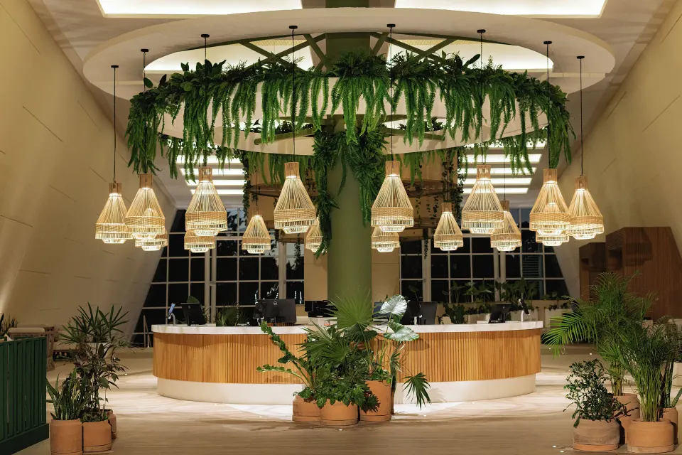 Front desk reception area with hanging plants at Grand Sirenis Riviera Maya Resort & Spa