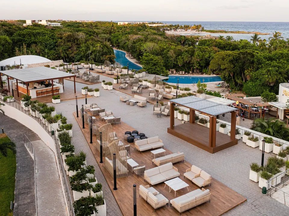 Rooftop lounge seating and cabanas overlooking pools and jungle at Grand Sirenis Riviera Maya Resort & Spa
