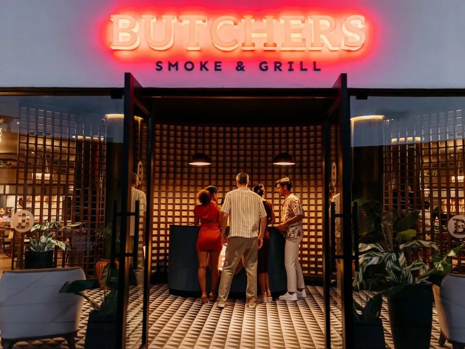 Guests entering Butchers Smoke & Grill entrance at Grand Sirenis Riviera Maya Resort & Spa