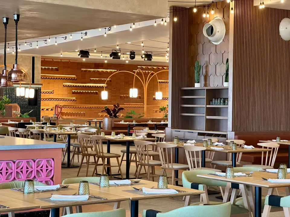 Casual restaurant interior with mixed seating and decorative wall features at Grand Sirenis Riviera Maya Resort & Spa