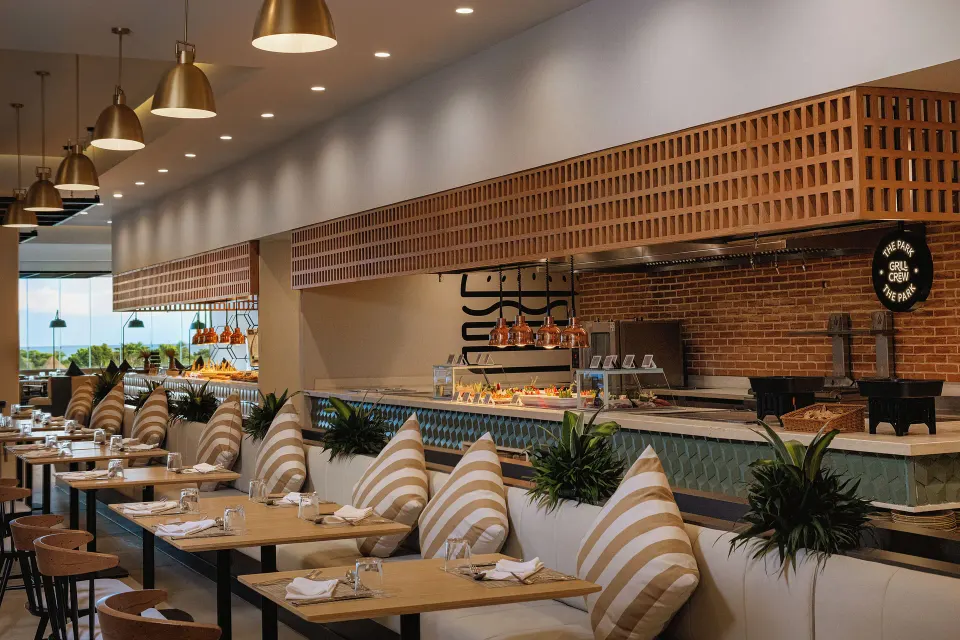 Casual dining room with striped cushions and service counters at Grand Sirenis Riviera Maya Resort & Spa