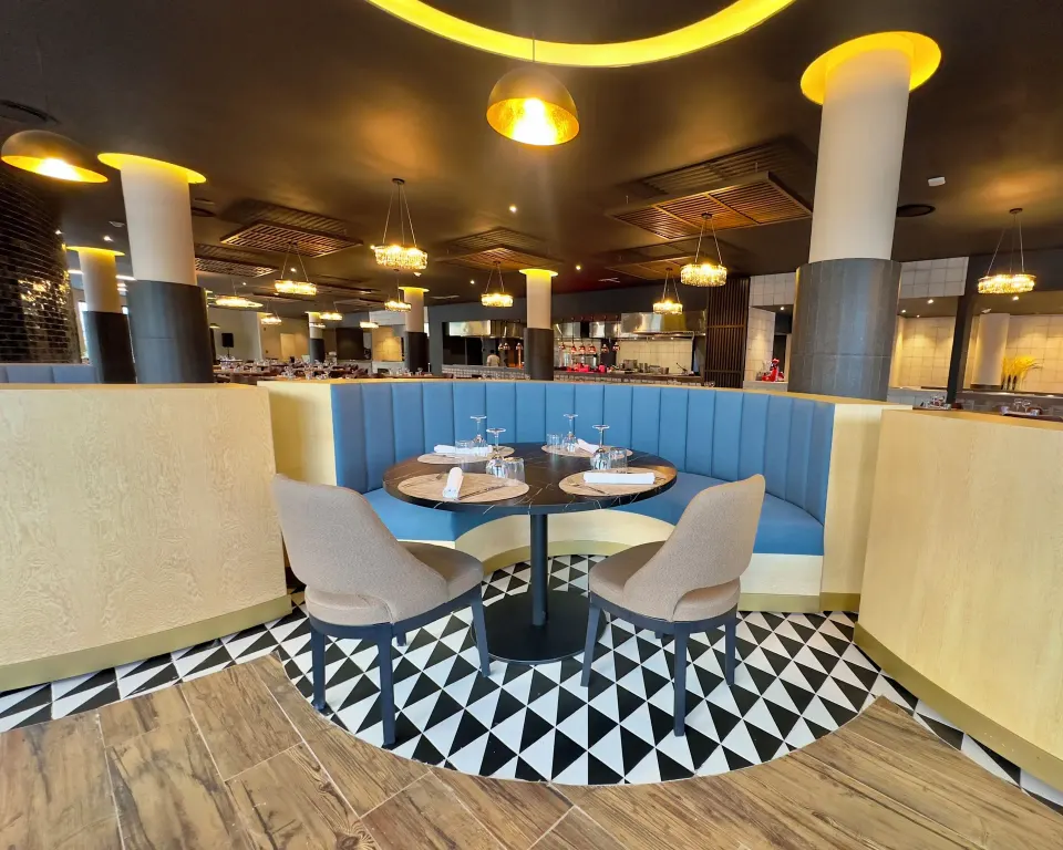 Intimate two-person table in a patterned-floor restaurant at Grand Sirenis Riviera Maya Resort & Spa